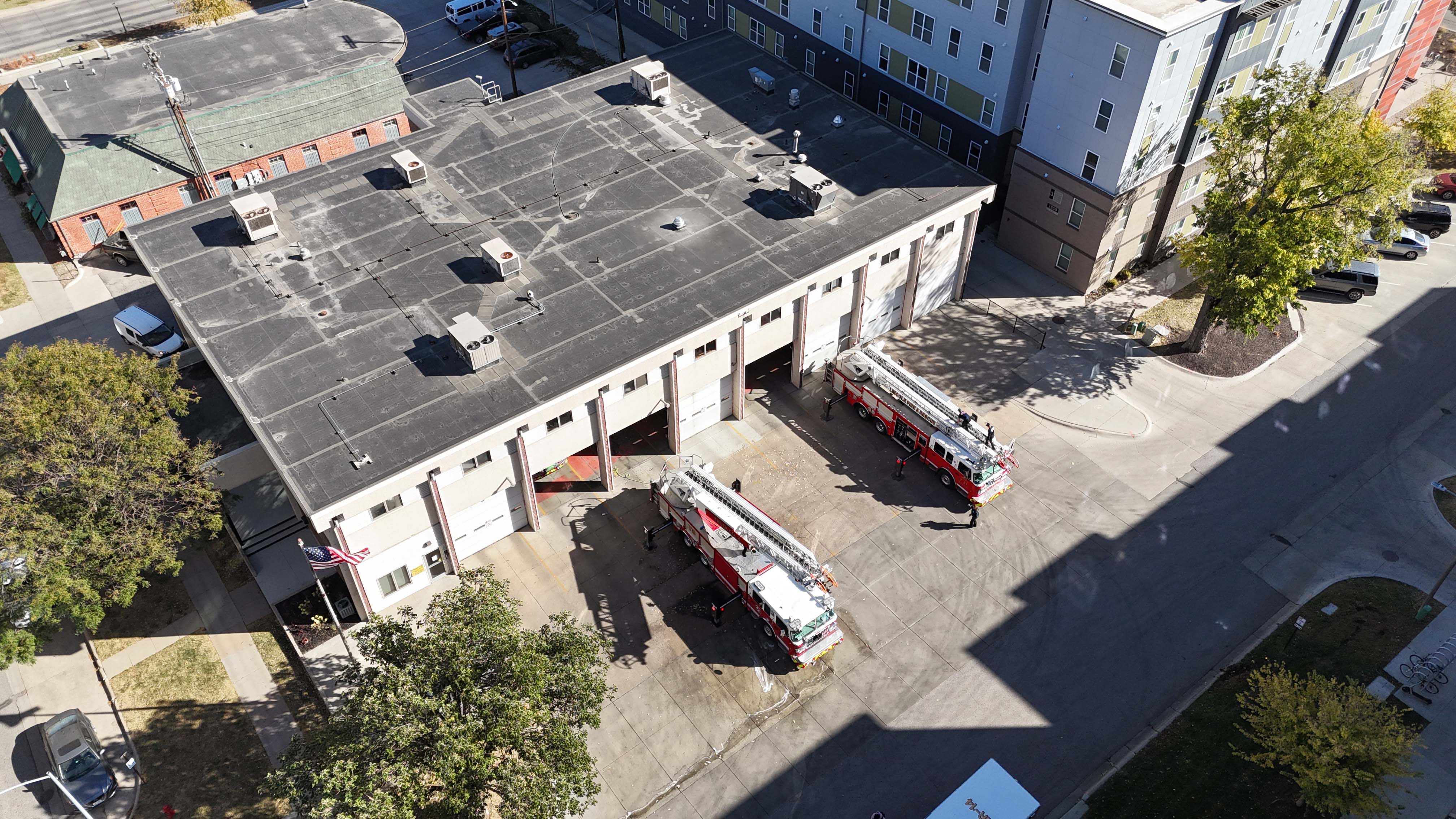 An ariel image of a fire station with two red firetrucks